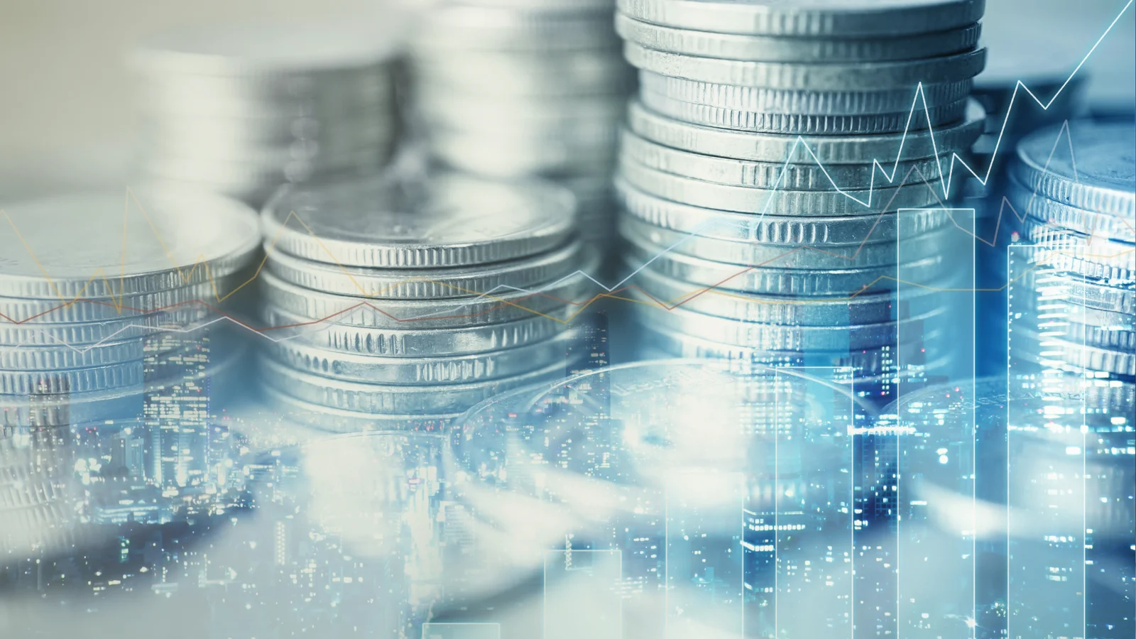 Stacks of silver coins layered over a night city skyline, with a rising line chart and bar chart overlaid in blue.