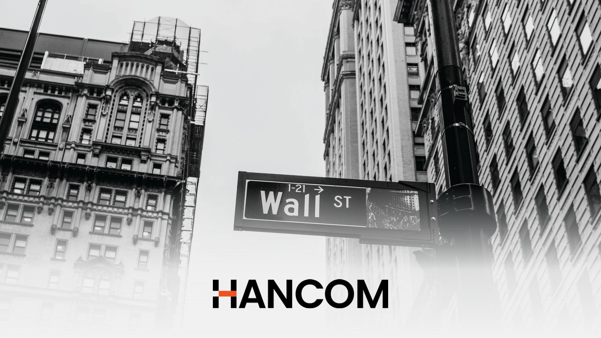Hancom wordmark below a Wall Street sign in a black-and-white photo of lower Manhattan