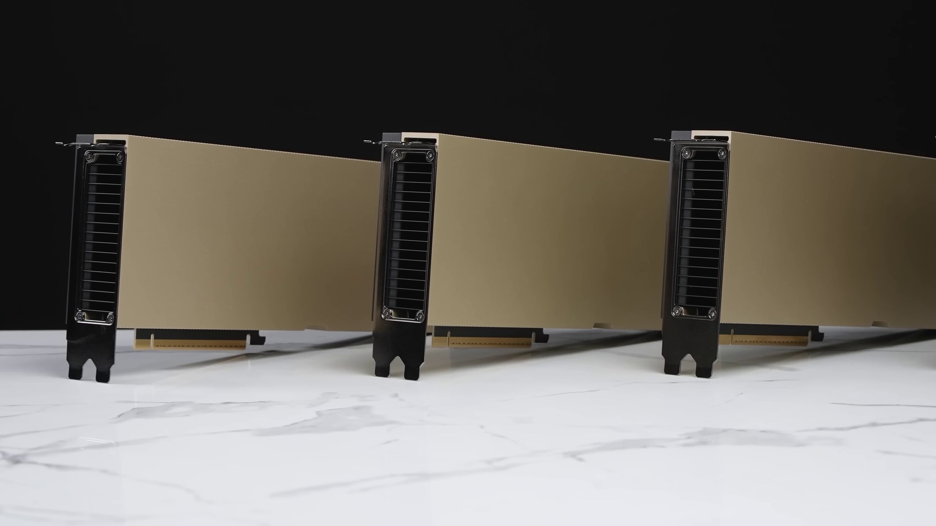 A row of Nvidia H100 graphics cards on a white surface